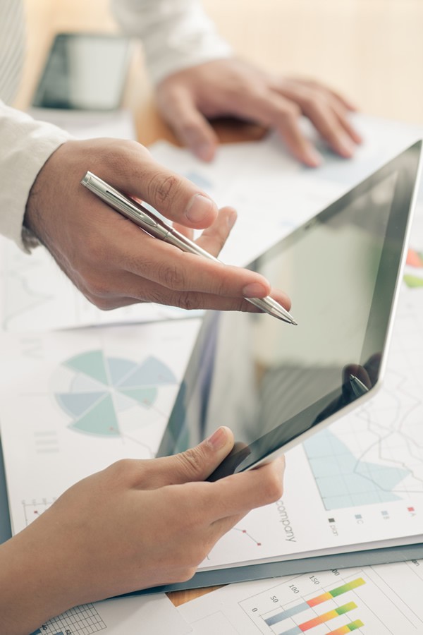 executives-pen-tablet Executive Meeting holding pen and tablet