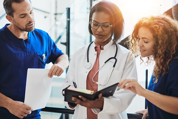 Woman Doctor with Two Nurses