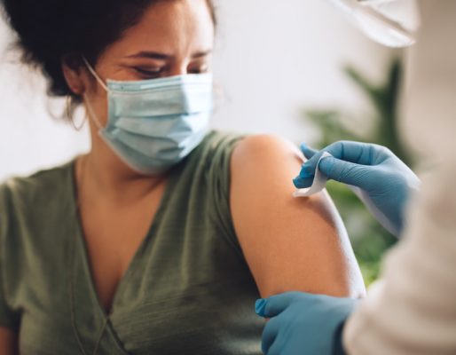 woman-covid-shot-mobile COVID Vaccination for Woman in Green Top - Mobile Version